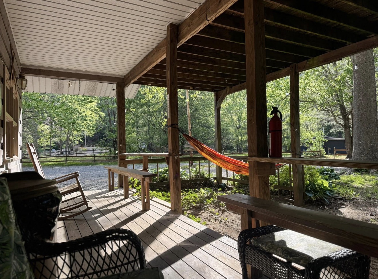 Covered porch with hammock and rocking chairs at the lodge